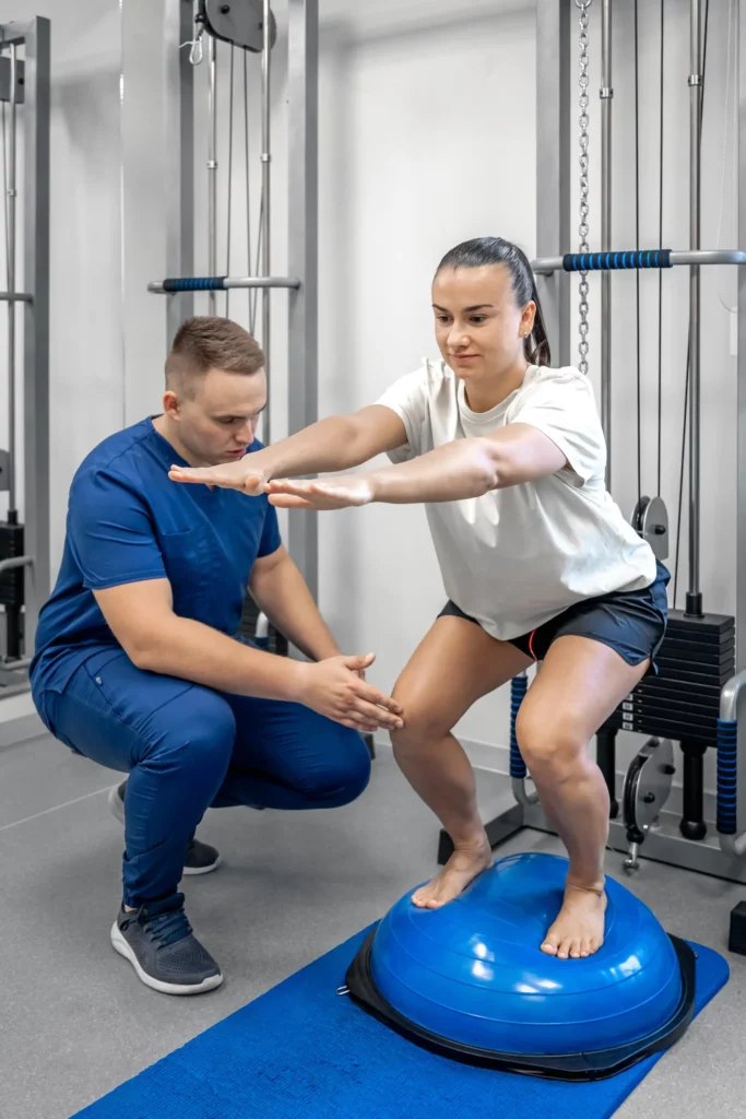 balance exercise with bosu ball woman and doctor 2023 11 27 05 27 03 utc